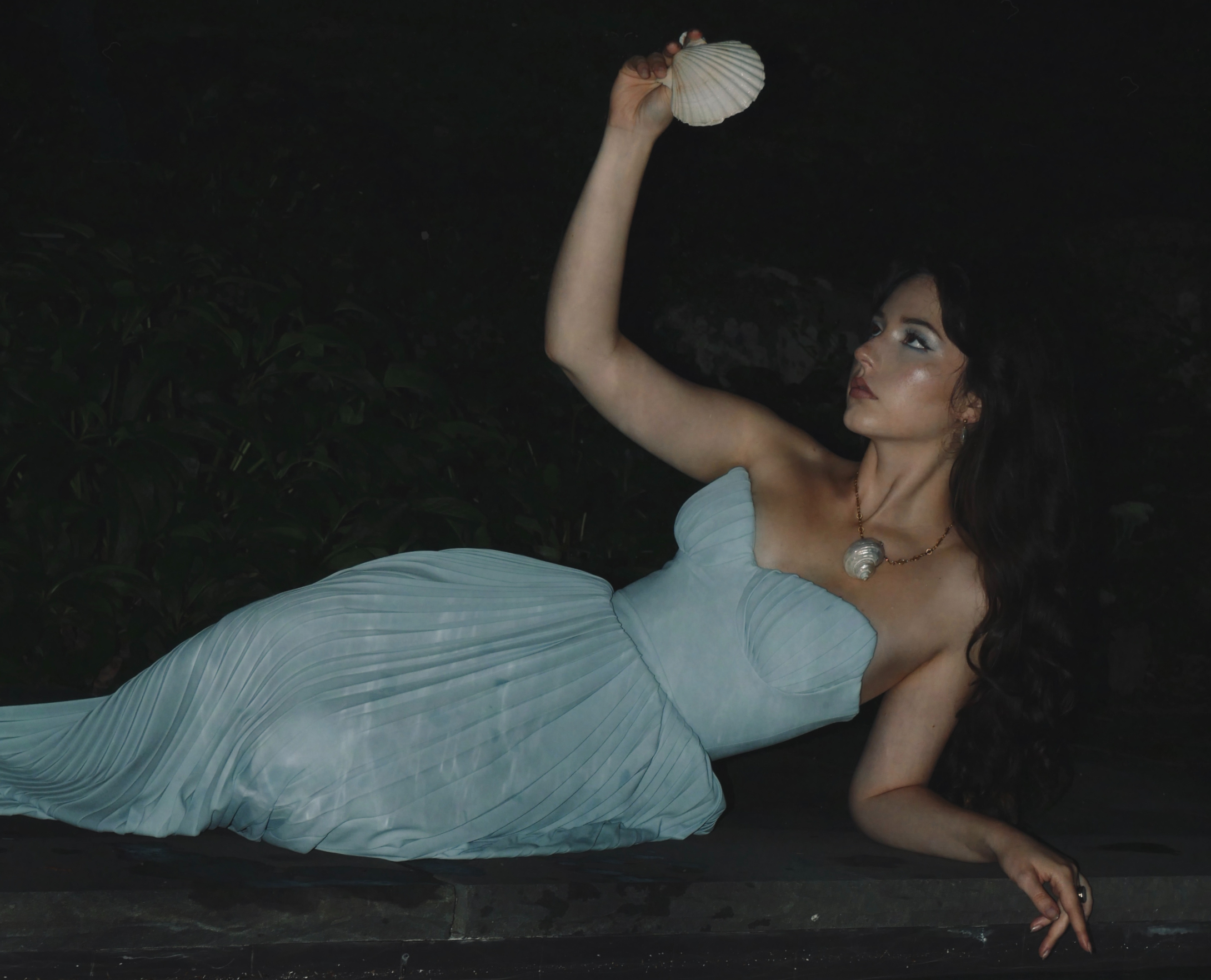 A woman in a soft blue gown holding a seashell — The Manhattan Mermaid Debut Collection